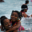 Lena Henderson and daughter Jade Powell, 6, swim in the R...